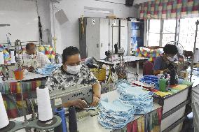 Mask production by people in Bangkok slum