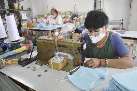 Mask production by people in Bangkok slum