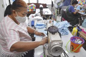 Mask production by people in Bangkok slum