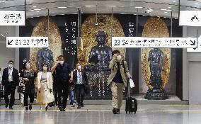 Buddhist statues photo at train station in Tokyo
