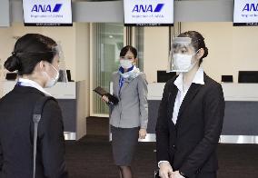 Airline workers' hospitality dilemma while wearing face masks