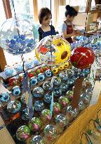Craftworkers paint wind chimes