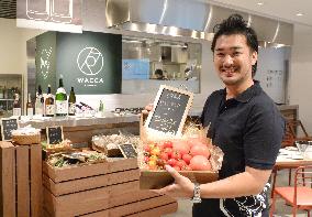 Owner of new Tokyo restaurant shows tomatoes from Fukushima's Iwaki
