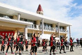 Pupils dance in front of new school building in northern Japan