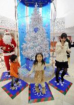 Children light up eco-friendly Christmas tree