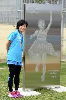 Olympic gold medalist marathoner Noguchi stands by monument
