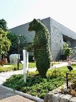 Bear-shaped tree stands at entrance to sculpture garden in Tokyo