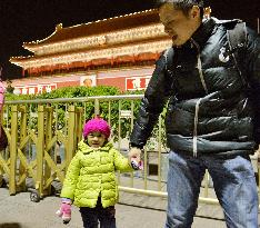 Father, child visit Tiananmen Gate in Beijing