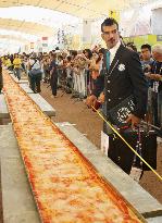 Chefs set Guinness record for longest pizza at Milan expo