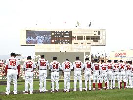 Carp players offer silent prayers in uniforms bearing number 86