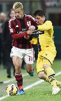 Japanese MF Honda of Milan tussles for ball with Parma player