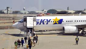 Passengers alight from plane at Ibaraki Airport, eastern Japan