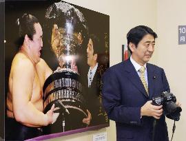 Abe attends news photography show