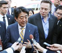 Tesla CEO takes Japan PM Abe for drive in EV