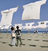 Over 1,000 T-shirts hang on beach as art event in Kochi, west Japan