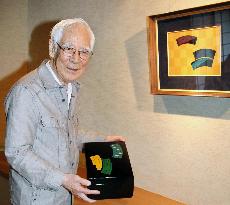 Artist Isoi shows trompe l'oeil tableau, letter box