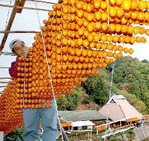 Persimmons, a good-luck talisman, being prepared for New Year se