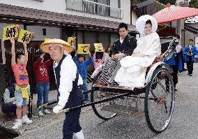 Newlyweds celebrated aboard rickshaw in western Japan town