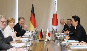 Japan's Abe, Germany's Merkel meet in Turkey