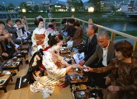 Kyoto teahouses open riverside seats for summer