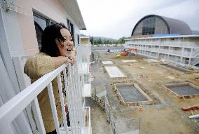 People moving into three-story temporary housing complex