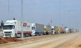 Aid supply trucks at Turkey-Syria checkpoint
