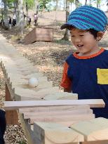 Kid marvels at "forest xylophone" at Hokkaido garden show venue