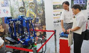 Radio-control robot for operating forestry machine among exhibits in Tokyo
