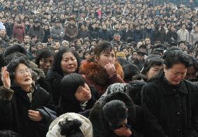 Citizens mourn before Kim's portrait