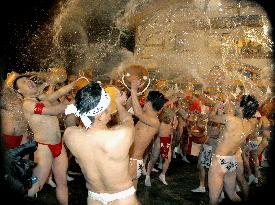 Men splash hot spring water at traditional Japanese festival