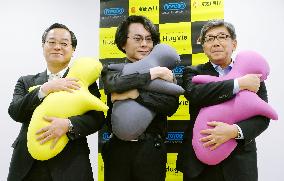 Human-shaped cushions with cellphone holders in head to hit stores