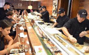 New York sushi chefs wear plastic gloves for cooking