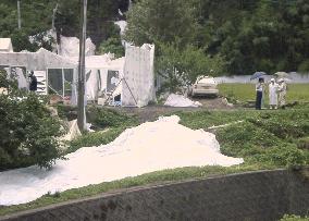 Pana Wave group removes white cloth from riverside