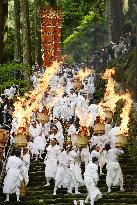 Big torches carried during summer Kumano shrine festival in western Japan