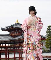 Pop group AKB48 member holds plate of Kyoto tourism ambassador