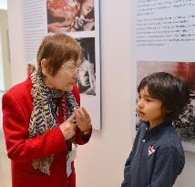 Young U.S. boy listens to A-bomb survivor at N.Y. exhibit