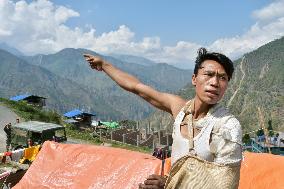 Man points to "lost village" afar in Nepal