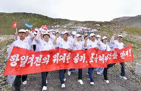 North Koreans march on highest peak to mark end of Japanese rule