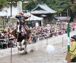 Horseback archer aims to shoot arrow at shrine festival in Nikko