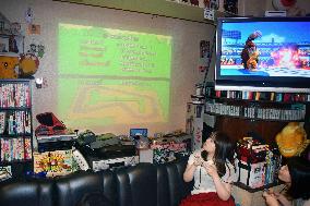 Customers at Osaka bar enjoy old video games