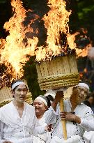Men carry big torches during summer Kumano shrine festival in western Japan