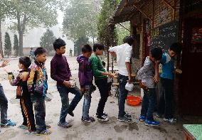 Students await breakfast at Chinese school promoting Mao's teachings