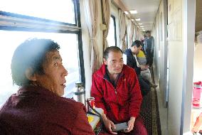 Sleeper train passengers relax outside compartments in China