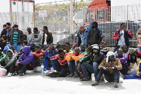 Immigrants await ferry for mainland on Lampedusa island