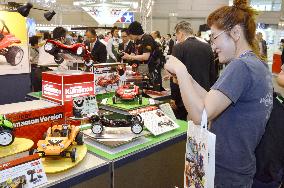 Visitor takes picture of radio controlled car at Shizuoka Hobby Show