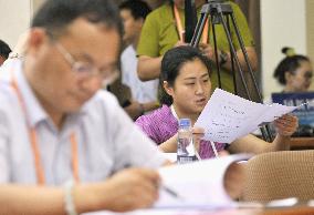 Reporters read China's GDP data