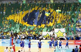 Brazilian flag formed by people at Rio gym during volleyball game
