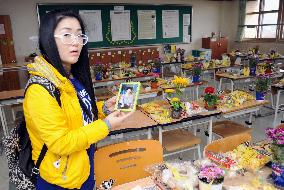 Mother of S. Korea ferry disaster victim visits son's classroom