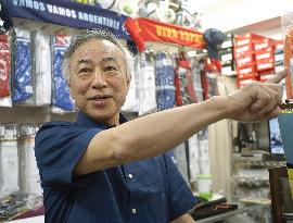 1st Japanese FIFA World Cup referee works at his sports gear shop