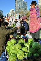 Beijing woman buys cabbage at one-air market